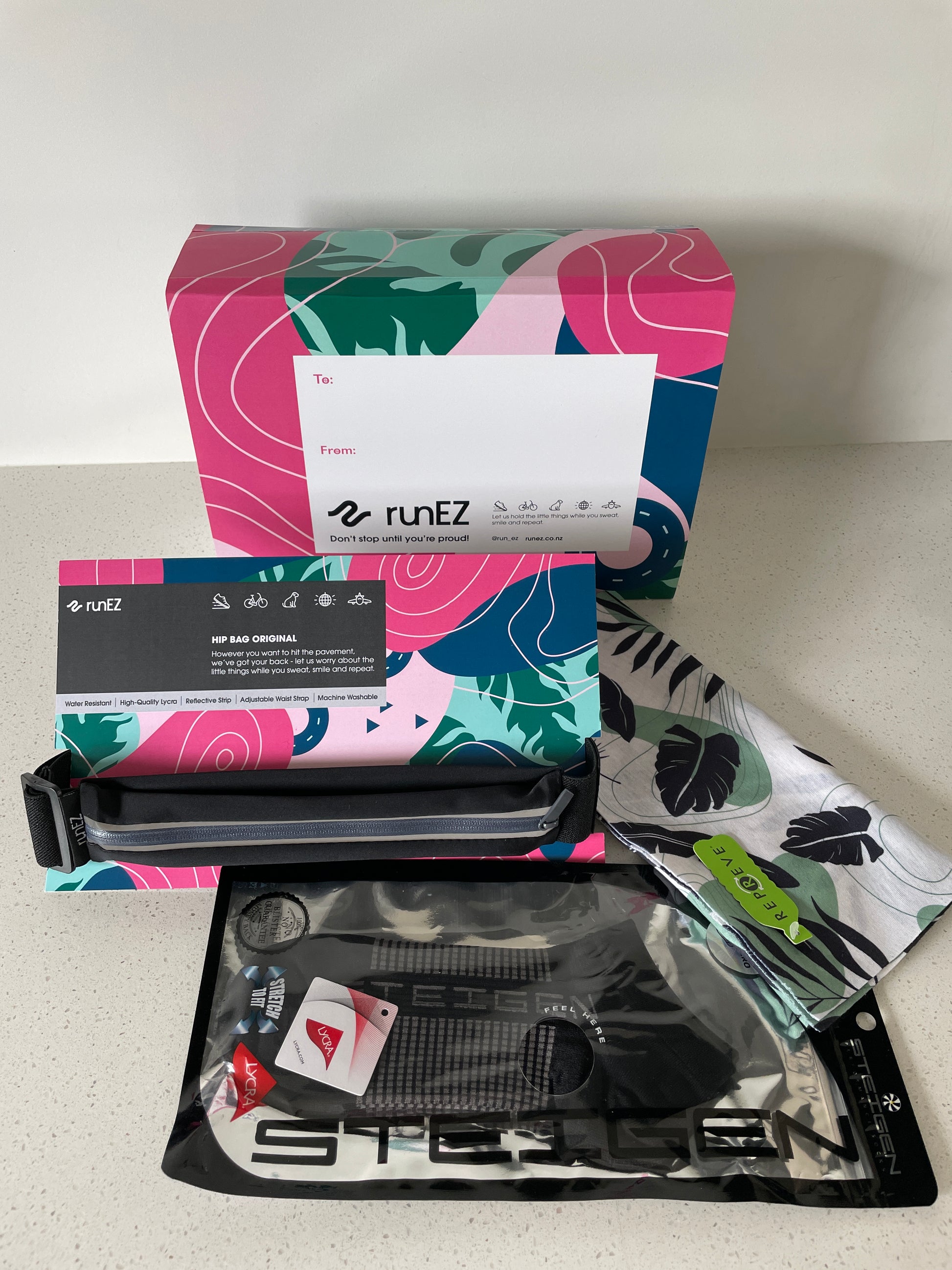 running belt gift pack with running socks, head band and fanny pack that holds any phone