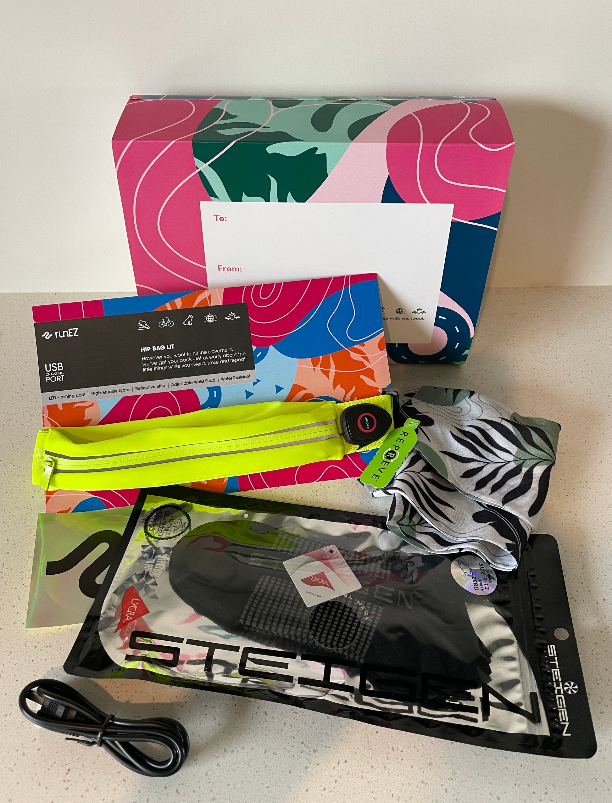 runner gift pack with bright running belt rechargable led light and charging cord with running socks, head band and fanny pack that holds any phone